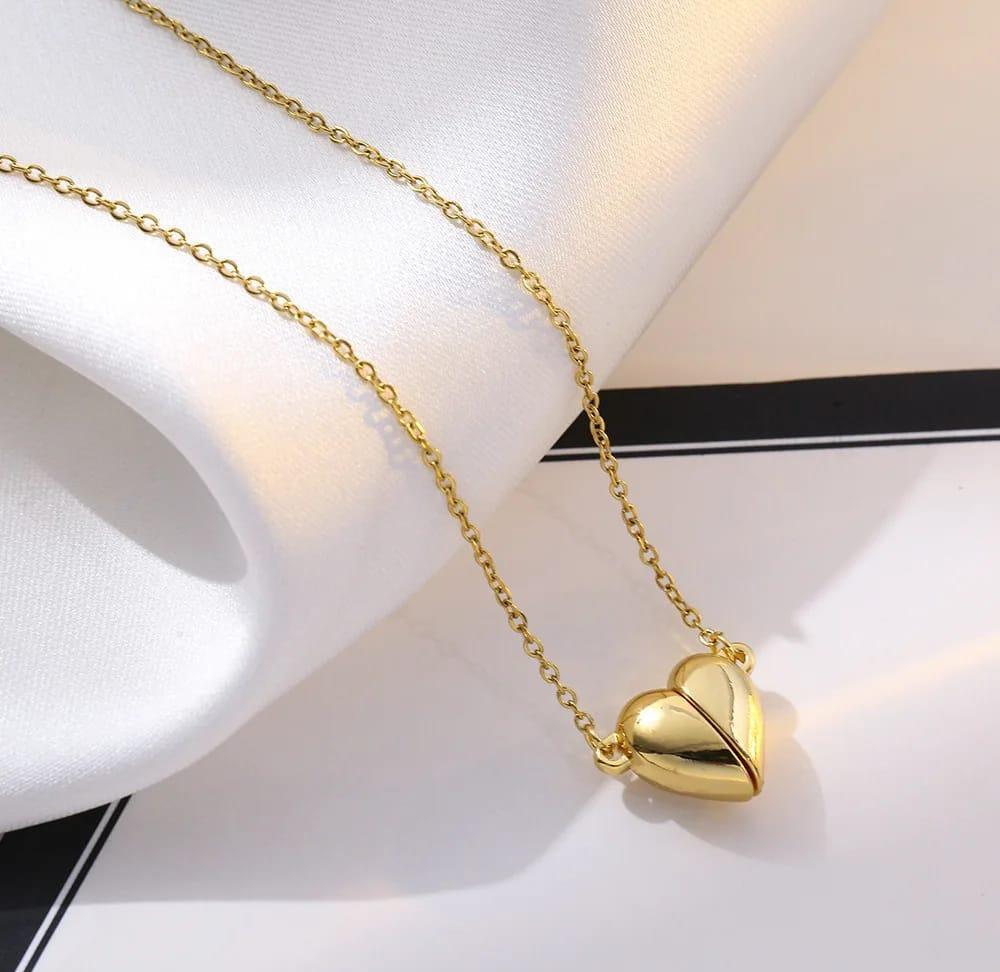 Gold heart-shaped pendant necklace on a white background