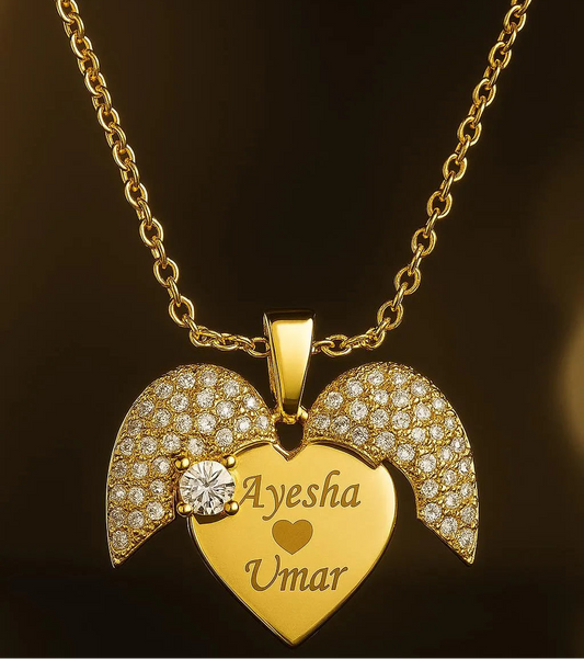 Gold necklace with a heart-shaped pendant and engraved names on a dark background